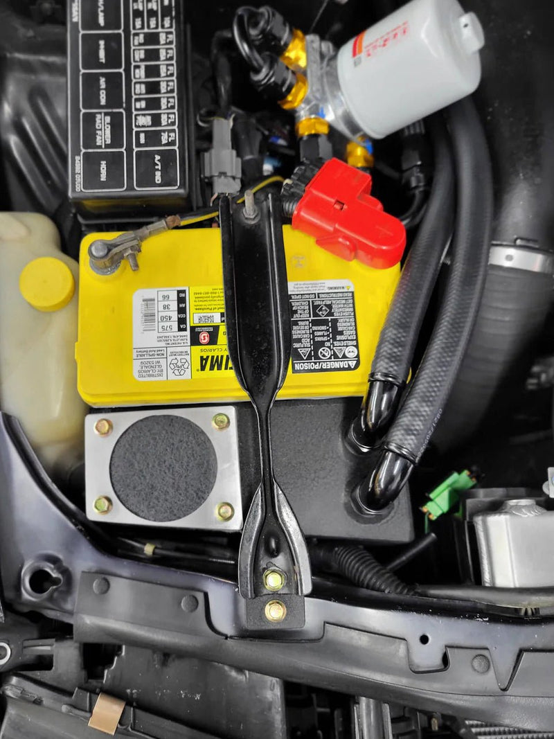 Load image into Gallery viewer, Black oil catch can separator installed in a Nissan R32 GTR engine bay next to a yellow Optima battery.