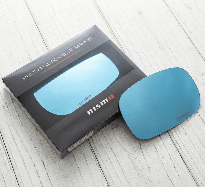 Load image into Gallery viewer, NISMO Skyline BNR34 Multi Function Blue Mirror Set packaging and mirror on wooden surface.