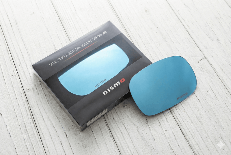 Load image into Gallery viewer, NISMO Skyline BNR34 Multi Function Blue Mirror Set packaging and mirror on wooden surface.