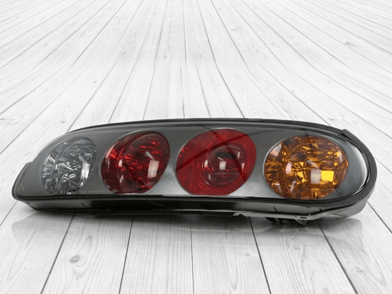 ギャラリービューアに画像をロードする, Genuine Toyota MK4 Supra taillight assembly with black housing and clear, red, and amber lenses.