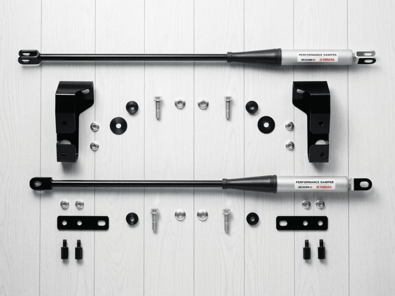 Load image into Gallery viewer, New Nissan R34 Skyline GTR Nismo Yamaha performance damper set with silver struts, black brackets, and hardware.