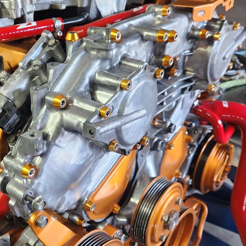 Load image into Gallery viewer, ZSPEC stainless and gold billet fastener kit installed on a VQ35DE engine front cover, including pulleys and hardware.