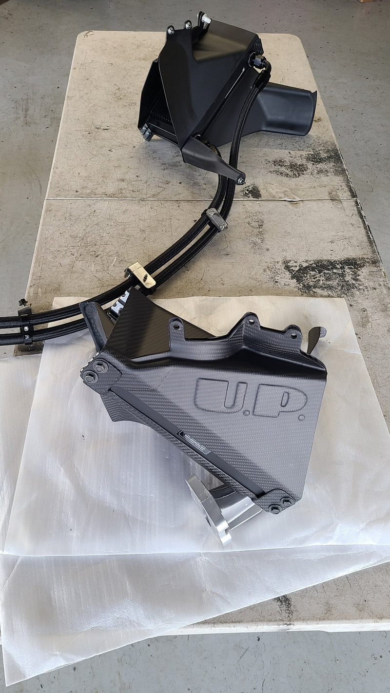 Load image into Gallery viewer, U.P.G. oil cooler kit with black carbon fiber ducting for R32 GTR, including braided lines and mounting hardware.
