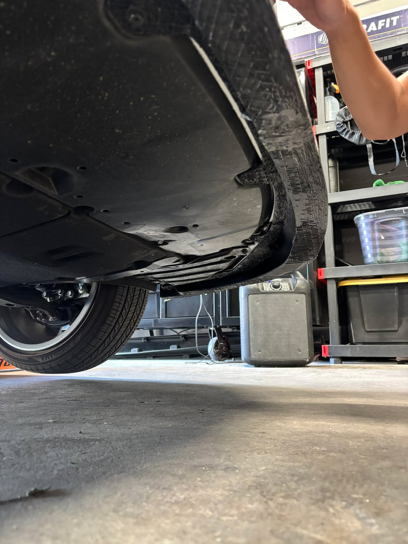 Load image into Gallery viewer, Black front lip for Toyota Corolla Hatchback (E210, 2023+) shown from underneath, displaying underside scuffs.