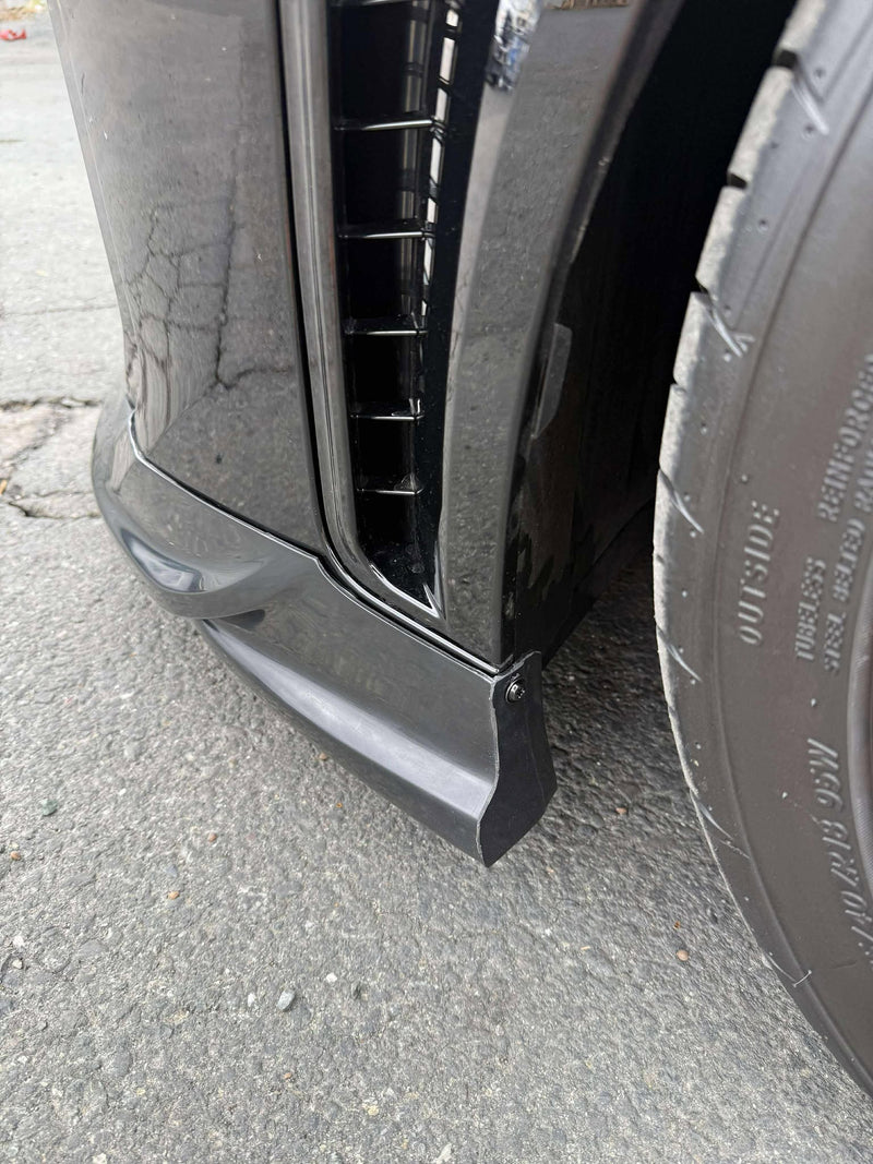 Load image into Gallery viewer, Gloss black front lip installed on a 2025+ Toyota GR Corolla (E210, Kouki) near the front tire.