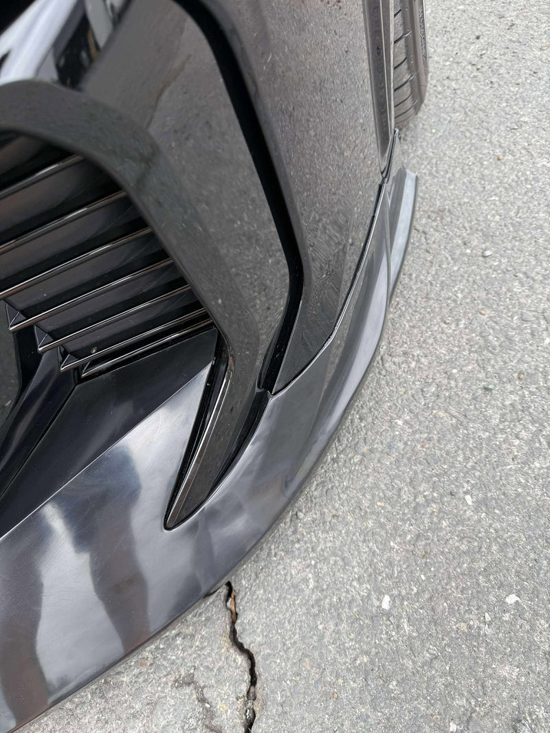 Load image into Gallery viewer, Gloss black front lip installed on 2025+ Toyota GR Corolla (E210, Kouki). Close-up view of passenger side corner.