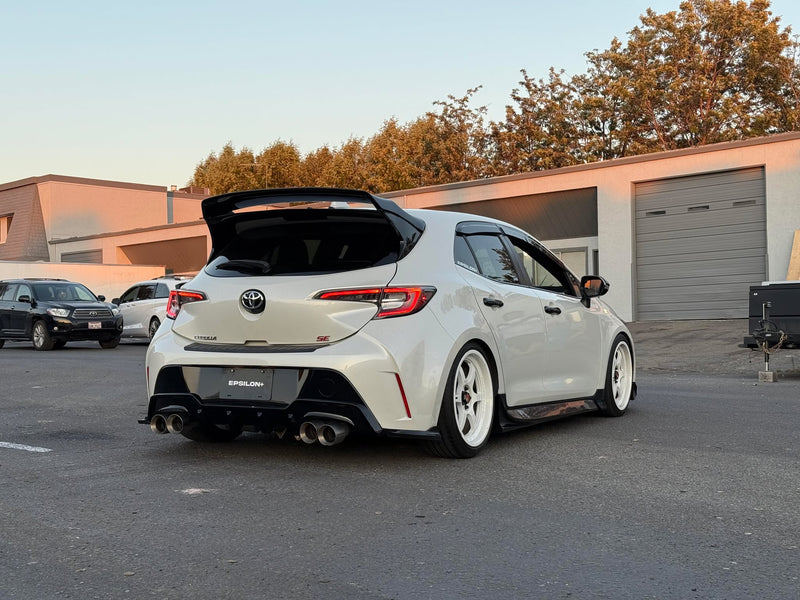 Load image into Gallery viewer, Black rear spats installed on a white Toyota Corolla Hatchback (E210, 2019-2025+).