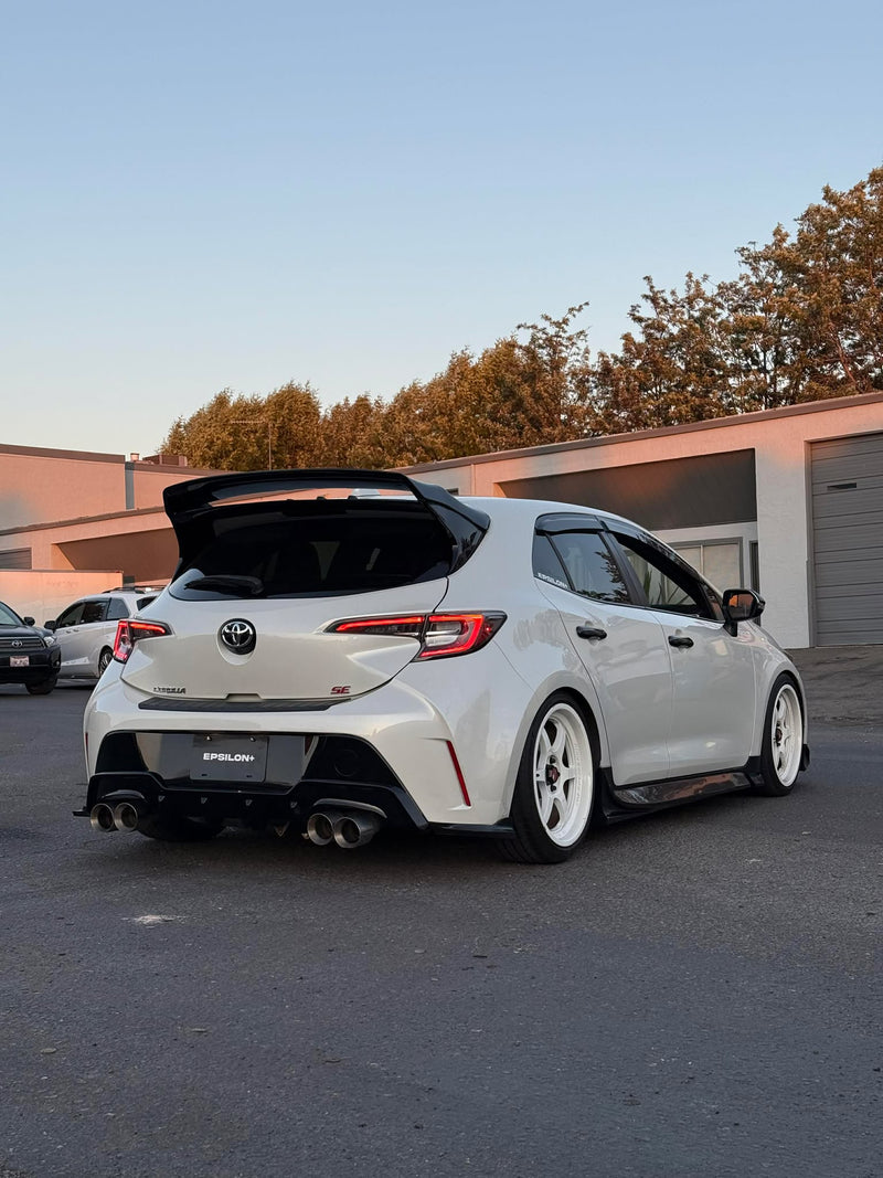 Load image into Gallery viewer, Black rear spats installed on a white Toyota Corolla Hatchback (E210, 2019-2025+).