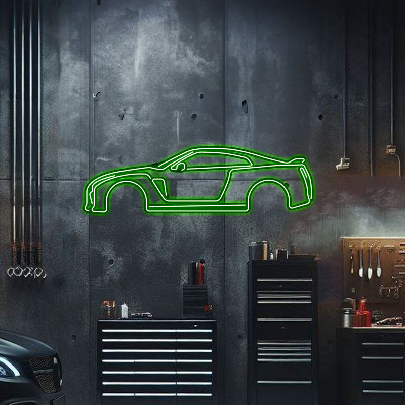 Load image into Gallery viewer, Green neon wall art of a Skyline GT-R R35 silhouette mounted on a dark workshop wall.