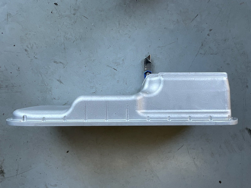 Load image into Gallery viewer, New JHK cast rear sump oil pan for RB20/25/26 engines, silver finish, shown from the side on a grey floor.