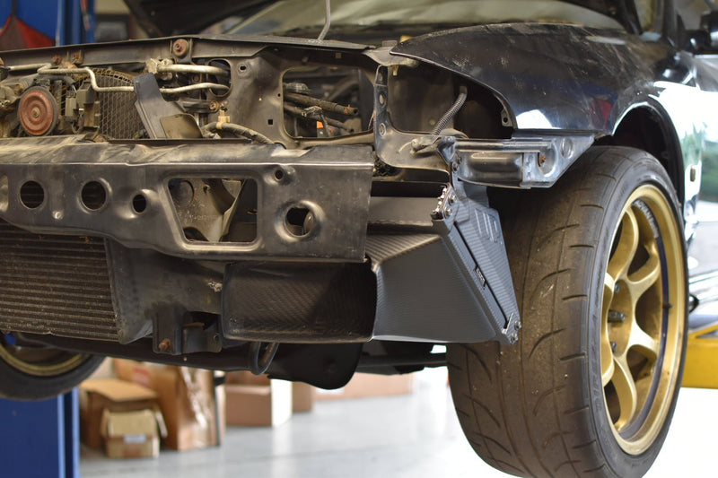 Load image into Gallery viewer, U.P.G oil cooler with black carbon fiber ducting installed on the front bumper of an R32 GTR.