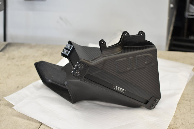 Load image into Gallery viewer, U.P.G carbon fiber oil cooler duct for Nissan R32 GTR. Black carbon finish with branded decal on protective paper.