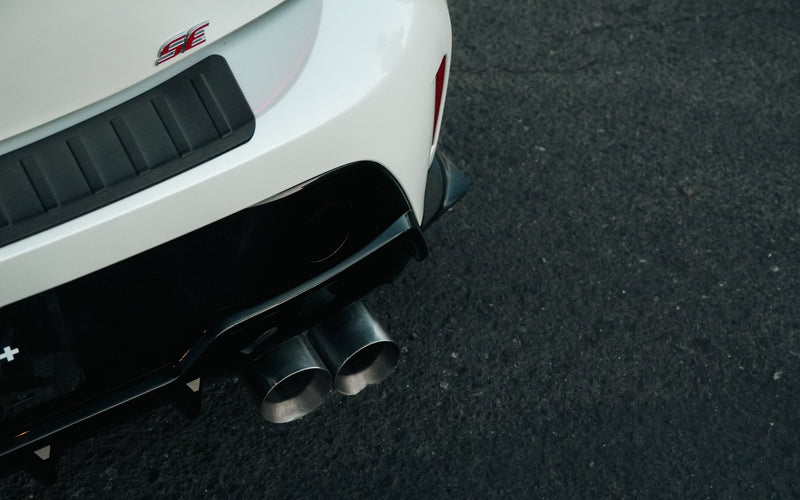 Load image into Gallery viewer, Gloss black rear spats on a white Toyota Corolla Hatchback (E210, 2019-2025+).
