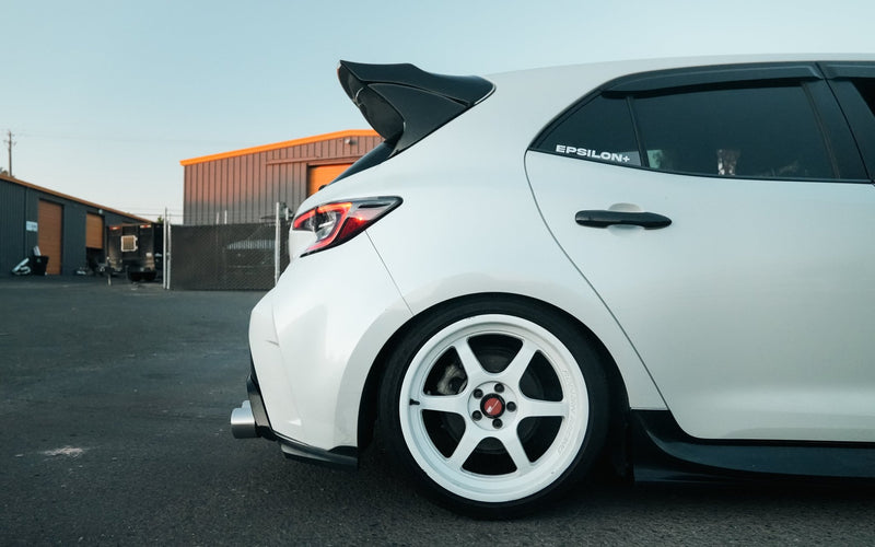 Load image into Gallery viewer, Black rear spats installed on a white Toyota Corolla Hatchback (E210).
