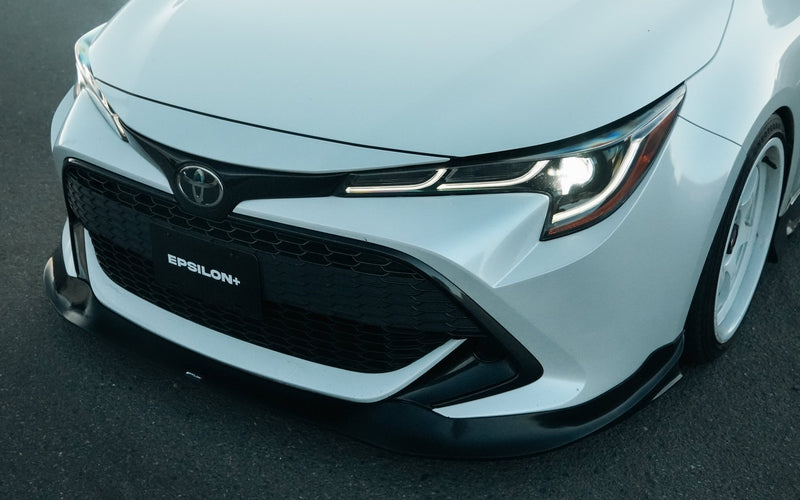 Load image into Gallery viewer, Black front lip installed on a white 2019-2022 Toyota Corolla Hatchback (E210 Zenki).