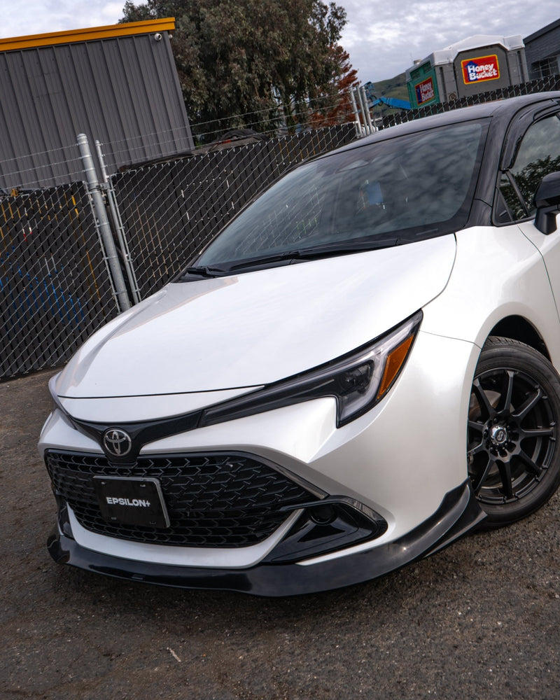 Load image into Gallery viewer, Gloss black front lip installed on a white 2023+ Toyota Corolla Hatchback (E210 Kouki).