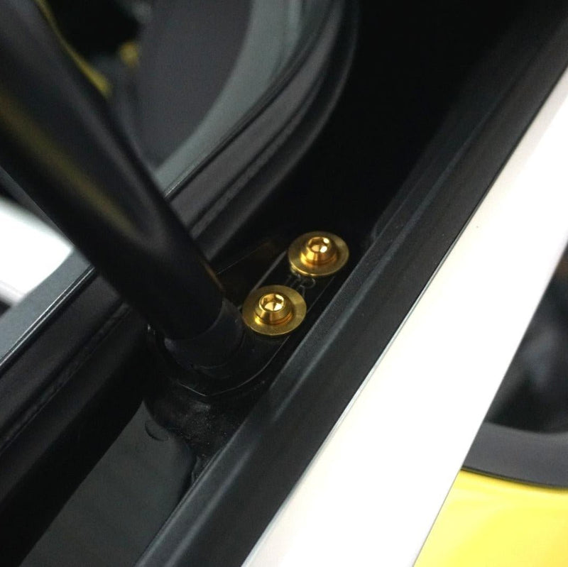 Load image into Gallery viewer, Gold titanium hatch strut fastener kit installed on a 2023+ Nissan Z RZ34.