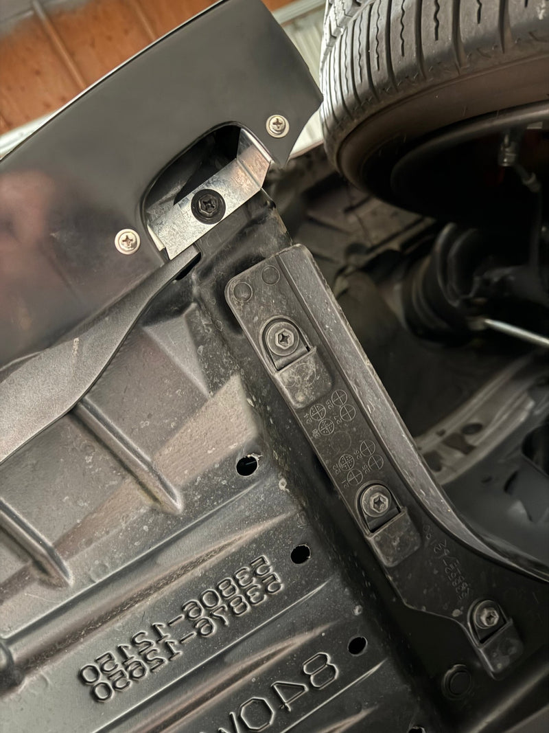 Load image into Gallery viewer, Black front lip installed on 2025+ Toyota GR Corolla (E210, Kouki), showing mounting hardware and assembly details.