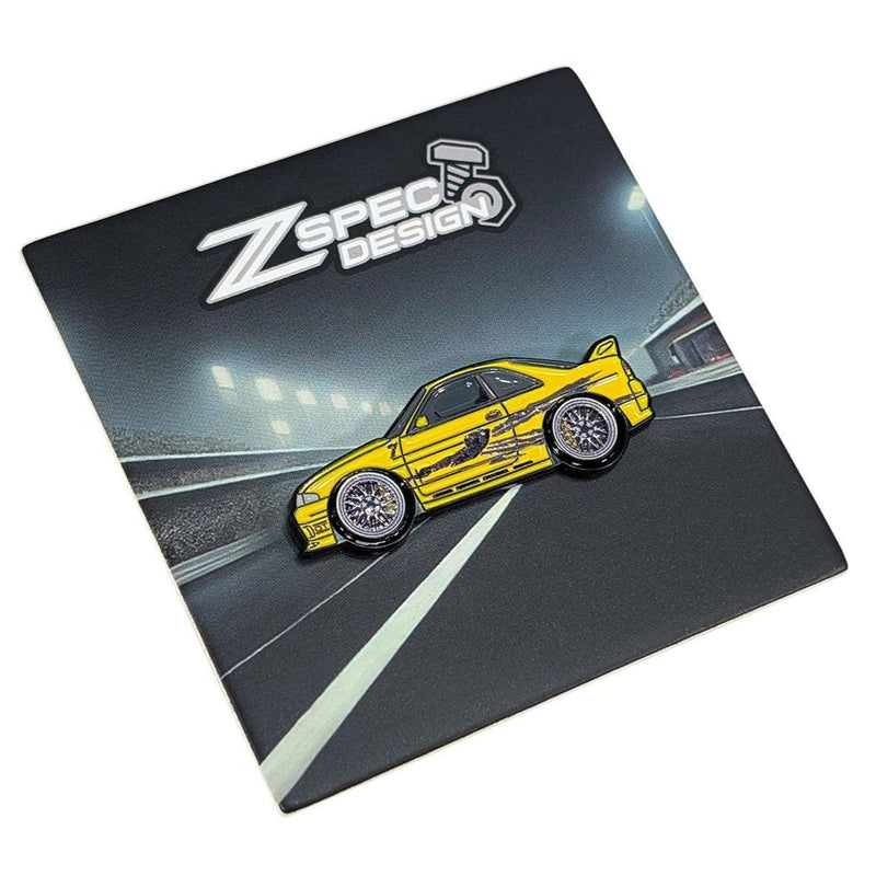 Load image into Gallery viewer, Yellow S15 Skyline collector enamel pin on a ZSPEC display card featuring a racetrack graphic.