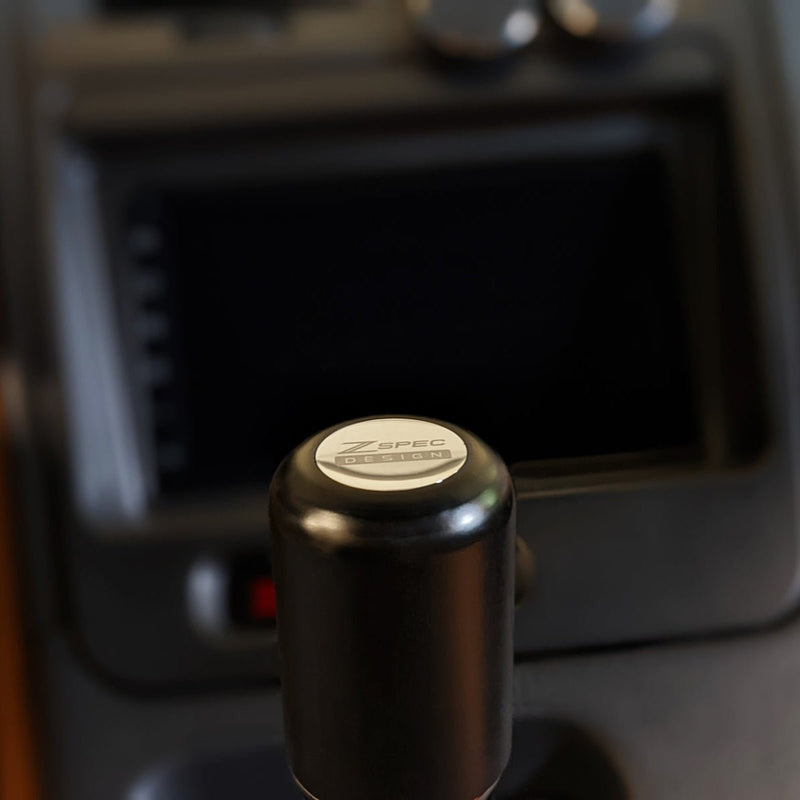 Load image into Gallery viewer, Black Delrin ZSPEC shift knob with stainless cap, installed in a Nissan 350Z/370Z or Infiniti G35/G37.