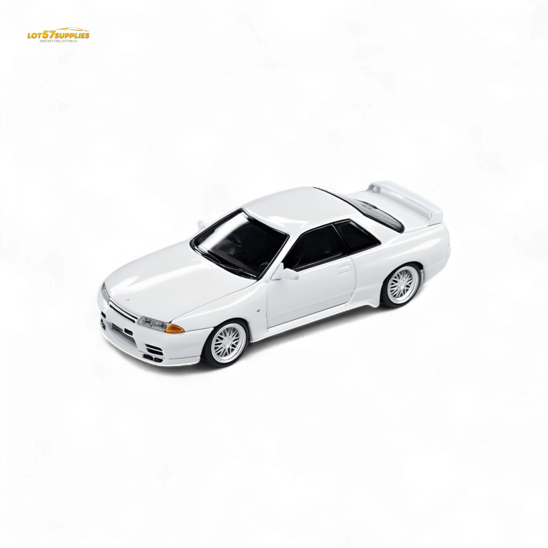 Load image into Gallery viewer, 1:64 scale Focal Horizon white Nissan Skyline GT-R R32 Nismo S-Tune diecast model car on a black background.