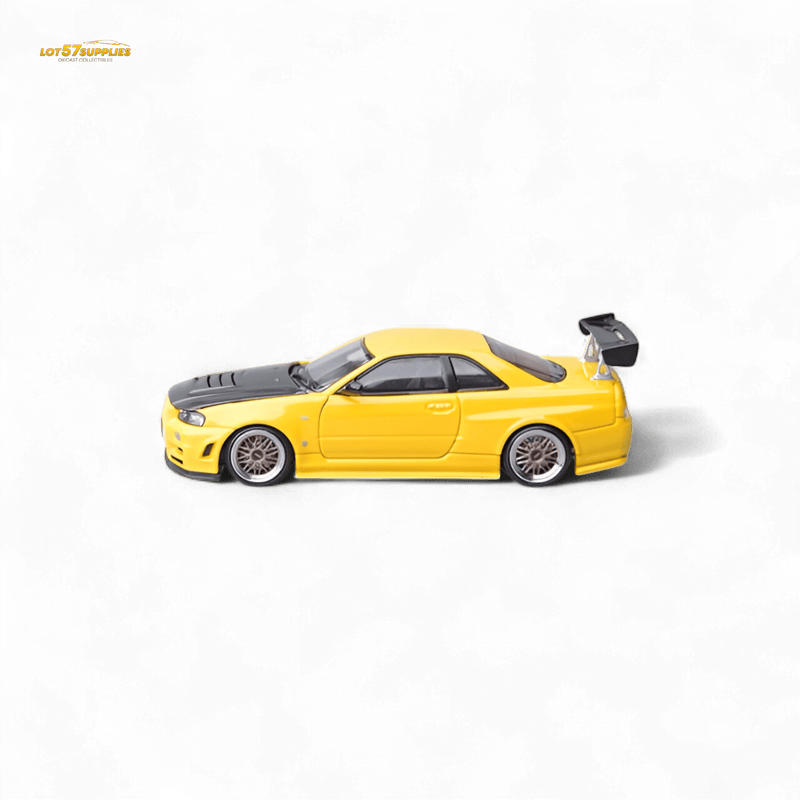 Load image into Gallery viewer, Yellow 1:64 scale Nissan Skyline GT-R R34 Z-Tune model car with black carbon fiber hood and rear wing.