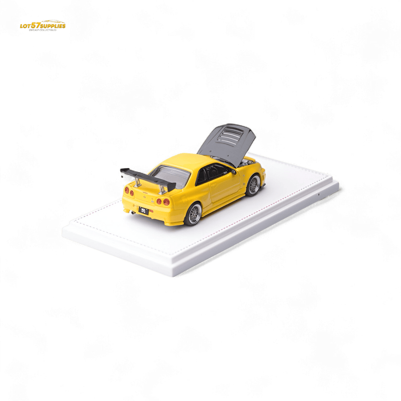 Load image into Gallery viewer, 1:64 scale yellow Nissan Skyline GT-R R34 Z-Tune diecast car with carbon hood, open engine bay, and display base.