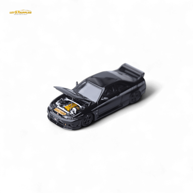 Load image into Gallery viewer, Black 1:64 scale Focal Horizon Nissan Skyline GT-R R33 Nismo 400R model car with open hood and visible yellow engine.