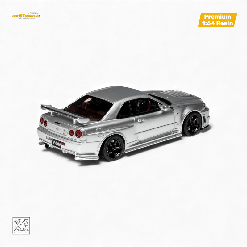 Load image into Gallery viewer, 1:64 scale silver Nissan Skyline GT-R R34 NISMO Z-Tune resin model car with black wheels against a black background.