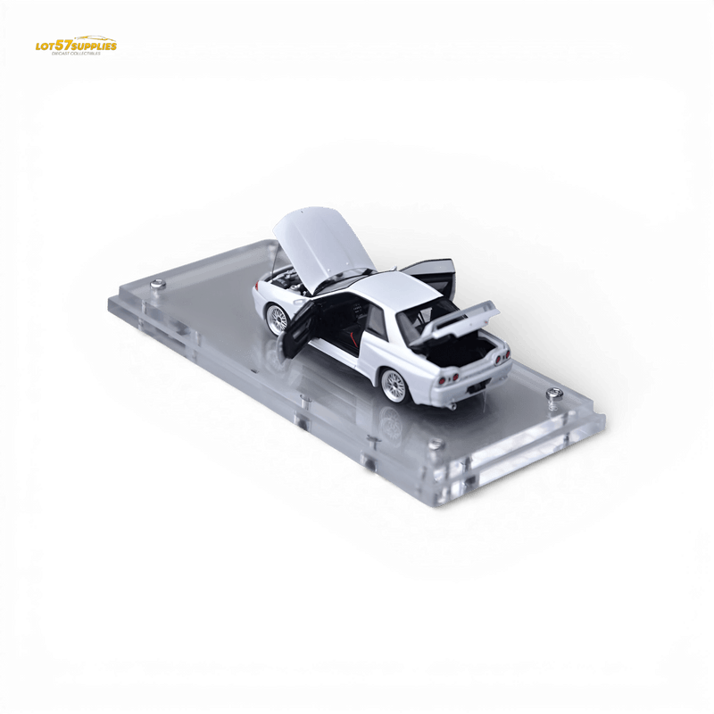 Load image into Gallery viewer, 1:64 scale white Nissan Skyline GT-R R32 Nismo diecast model with opening hood, doors, and trunk on a display base.