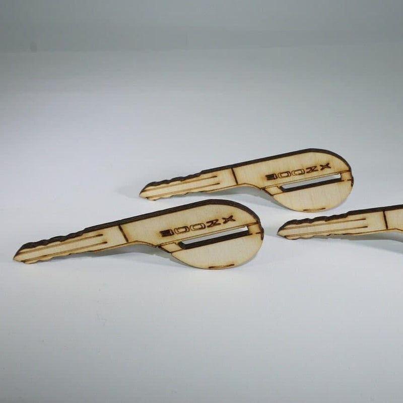 Load image into Gallery viewer, Set of four laser-engraved light birch wood Z32 Nissan 300ZX key ornaments on a white background.