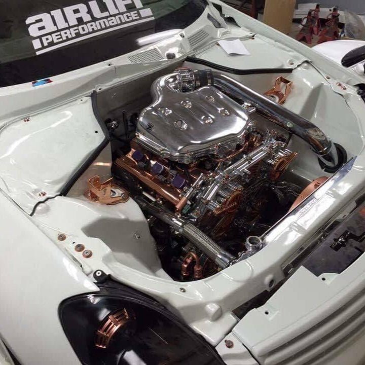 Load image into Gallery viewer, ZSPEC Stage-3 copper and stainless fastener kit installed in a clean 2003-2008 Infiniti G35 engine bay.
