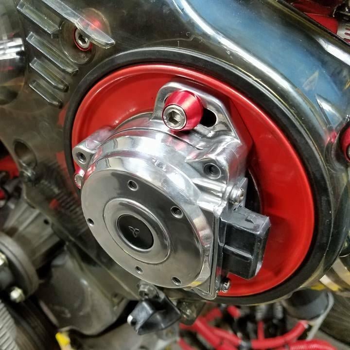Load image into Gallery viewer, Red ZSPEC stainless-billet crank angle sensor bolts installed on a Nissan Z32 or GT-R engine.