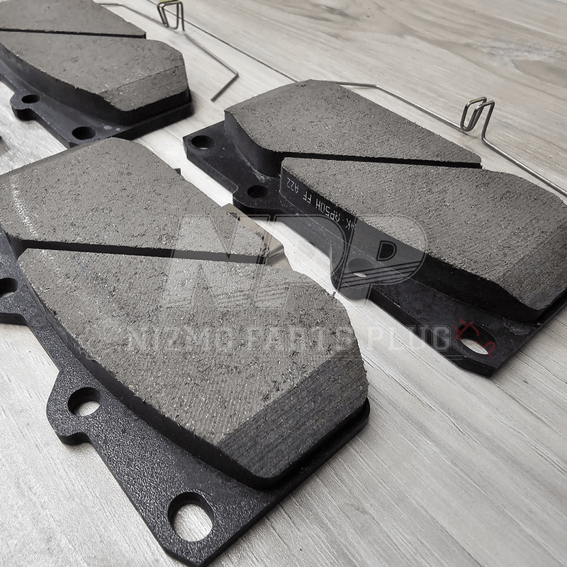 Load image into Gallery viewer, Brake pads on a wooden surface with a brand logo.
