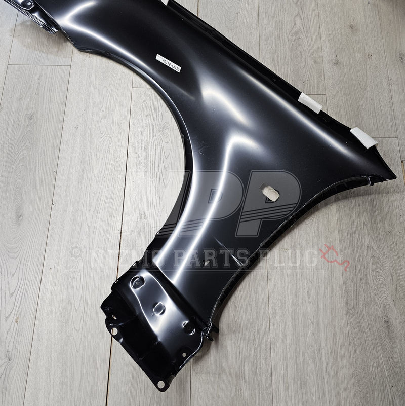 ギャラリービューアに画像をロードする, New black RH front fender for R34 Nissan Skyline GTR on wood floor.