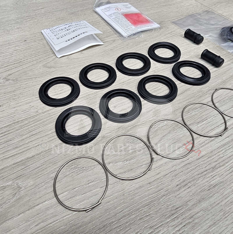 Load image into Gallery viewer, Nissan R34 Skyline GTT Rear Caliper Seal Rebuild Kit - NizmoPartsPlug