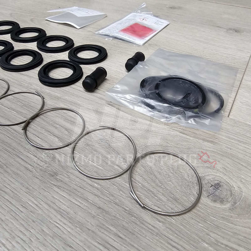 Load image into Gallery viewer, Nissan R34 Skyline GTT Rear Caliper Seal Rebuild Kit - NizmoPartsPlug