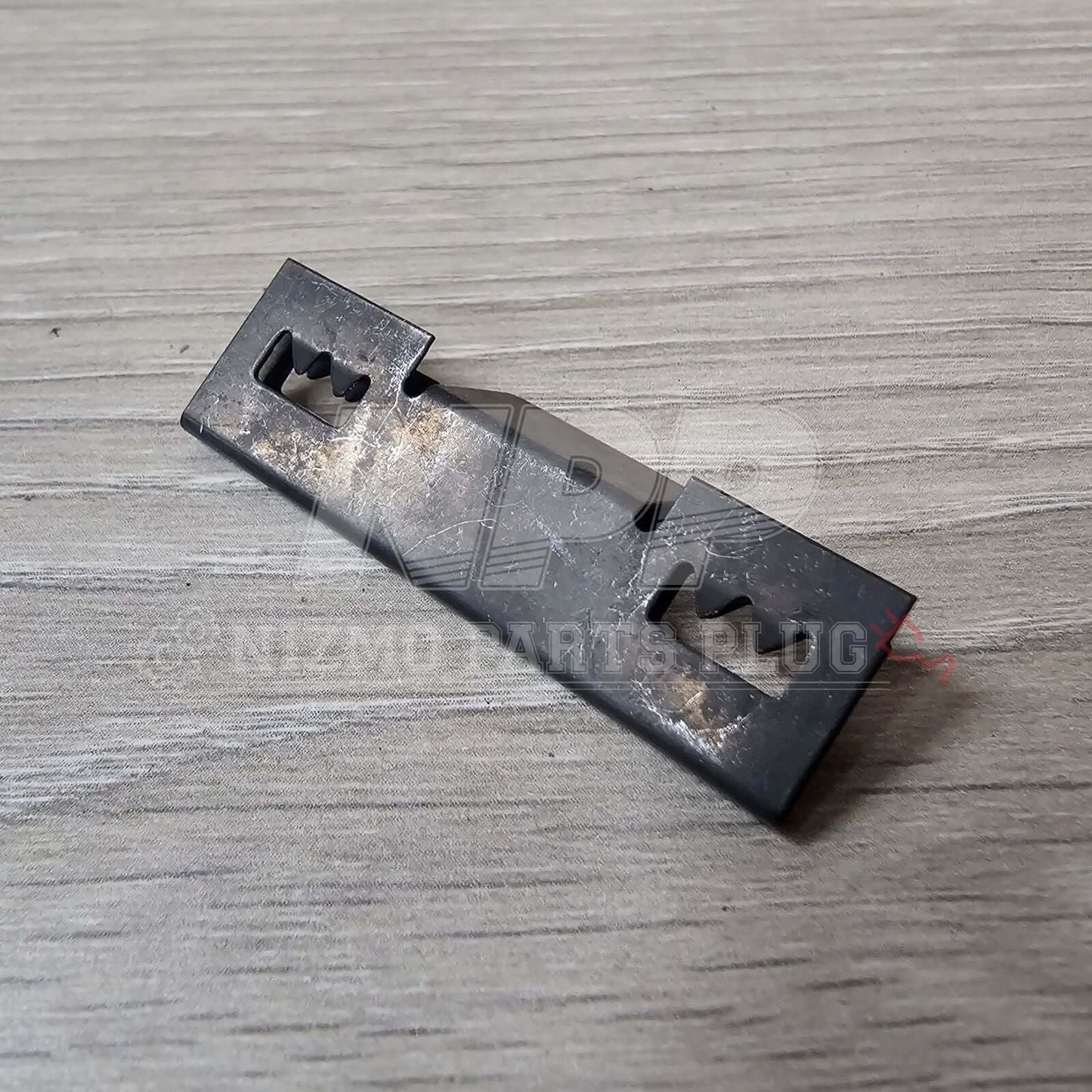 Nissan R32 Skyline GT-R Front Bumper Lower Grill Mounting Pressure Clip on a wooden surface