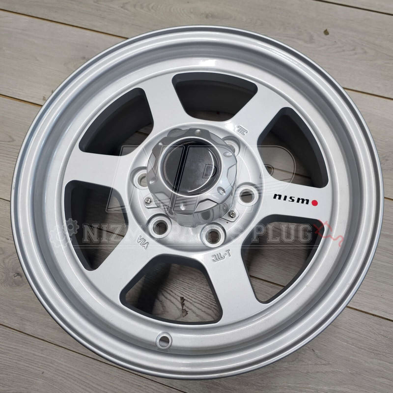 Cargue la imagen en el visor de la galería, Nismo Frontier Rays Engineering TE37X Wheel Assembly 16x7 6 lug, silver wheel with 6 spokes on wooden surface
