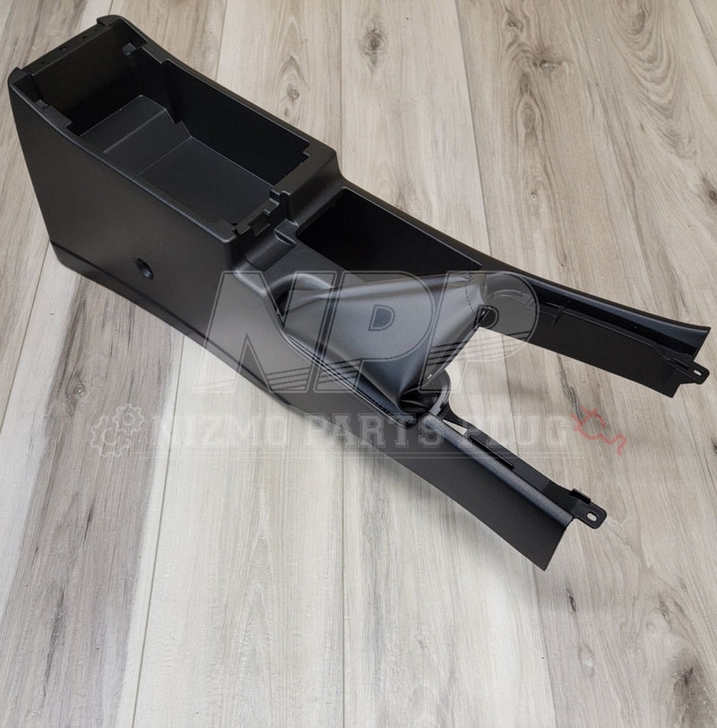 Load image into Gallery viewer, Black Nissan R34 Skyline center console with hand brake boot, shown in clean, excellent condition.
