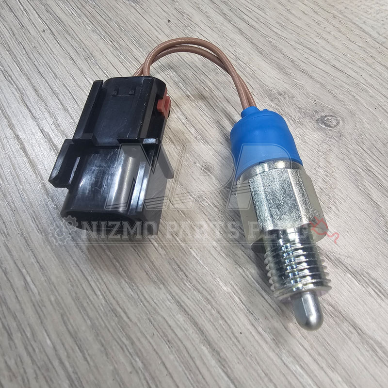 ギャラリービューアに画像をロードする, New Nissan neutral safety switch for R34, S14, and S15 with metal threaded body, blue collar, and black connector.
