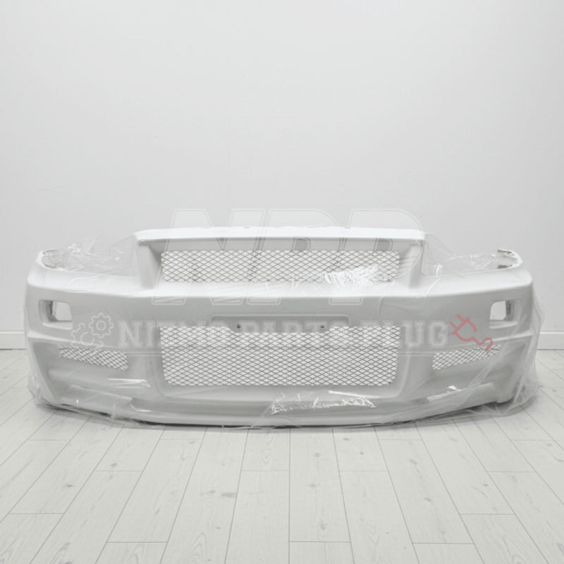 Load image into Gallery viewer, New, white Nismo Z-Tune front bumper assembly for Nissan R34 Skyline GTR, wrapped in protective plastic.