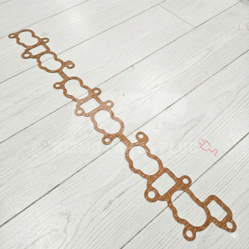 Load image into Gallery viewer, Nissan Skyline GTR RB26DETT Intake Manifold To Cylinder Head Gasket on a wooden floor.
