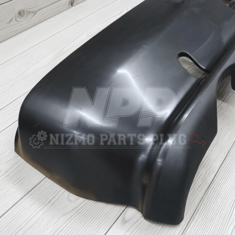 Load image into Gallery viewer, Black Nissan R32 Skyline GTR rear bumper assembly, shown from an angled top-down view on a wooden background.