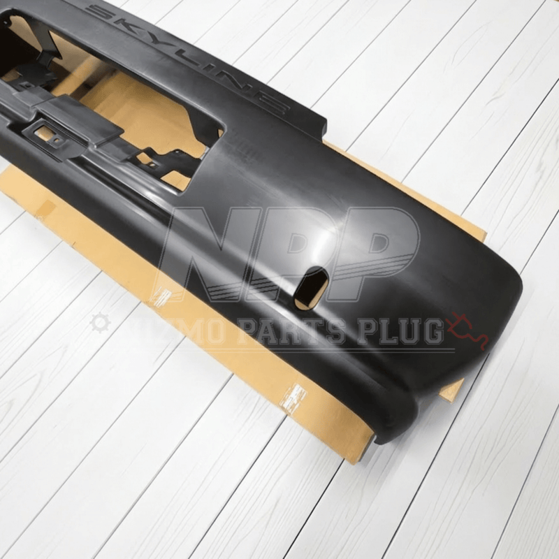 Load image into Gallery viewer, Black Nissan R32 Skyline GTR rear bumper assembly on cardboard backing.