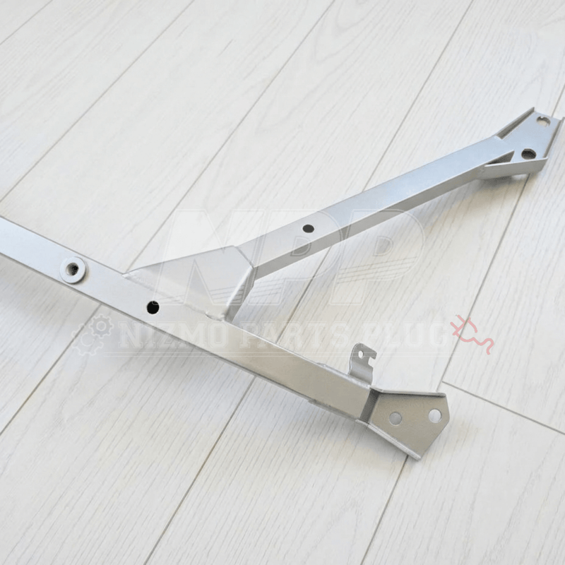 Load image into Gallery viewer, Nismo BNR34 GTR silver front floor reinforcement bar assembly in excellent condition on a white wood background.