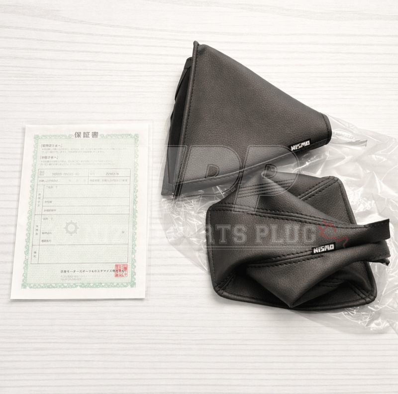 Load image into Gallery viewer, New black leather NISMO R32 GTR shift and hand brake boot set with warranty document in plastic packaging.