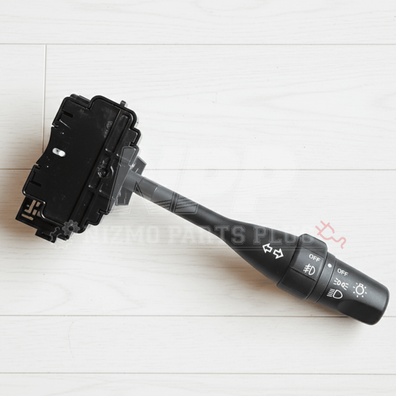 Load image into Gallery viewer, Black Nissan R33 GTR turn signal and headlight switch assembly with fog light control on a white wood background.