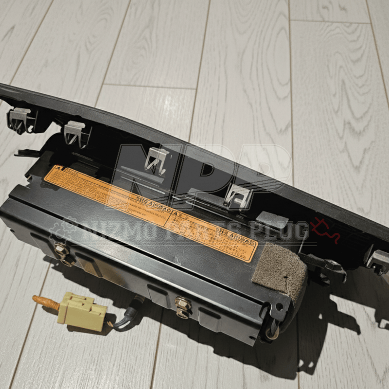 Load image into Gallery viewer, Nissan R34 Skyline black passenger SRS airbag assembly with warning label and yellow plug, in good pre-owned condition.