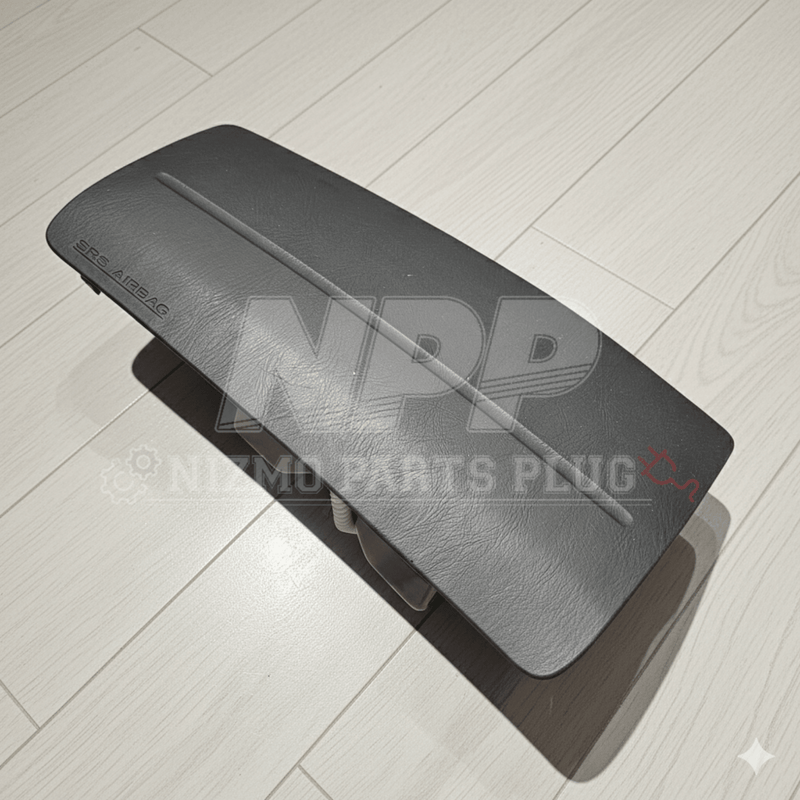 Load image into Gallery viewer, Grey Nissan R34 Skyline passenger SRS airbag assembly in excellent condition, featuring clean textured plastic surface.